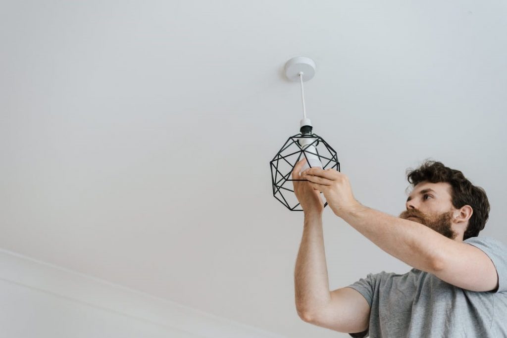 A remote worker installing new lighting