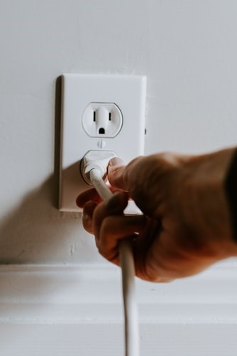 A man plugging in a socket